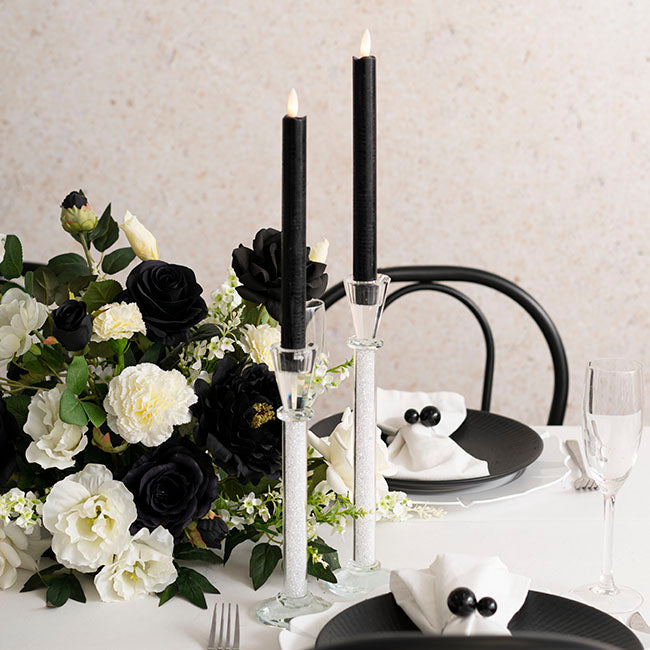 Wax LED Trueflame Dinner Taper Candle 2PK Black (2.2x24cmH) with flowers on table display
