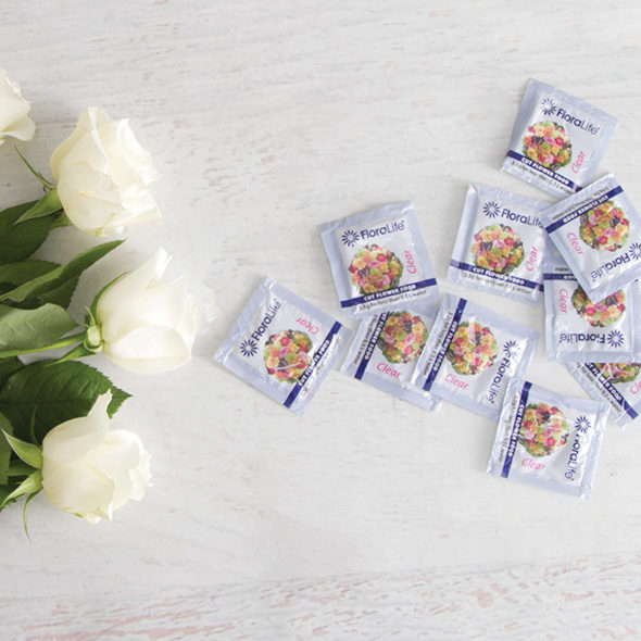 fresh cut roses and flower food sachets