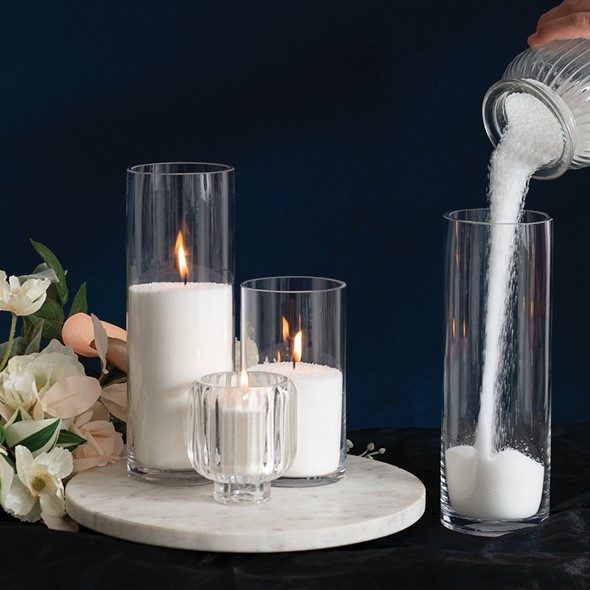 pouring candle sand into a vase